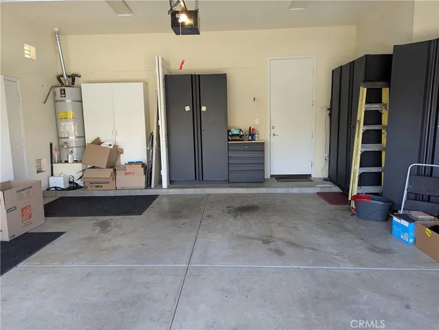 a view of a storage room with furniture and a chandelier