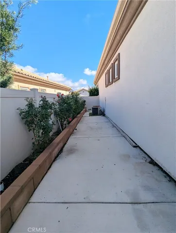 a view of house with backyard and sitting area