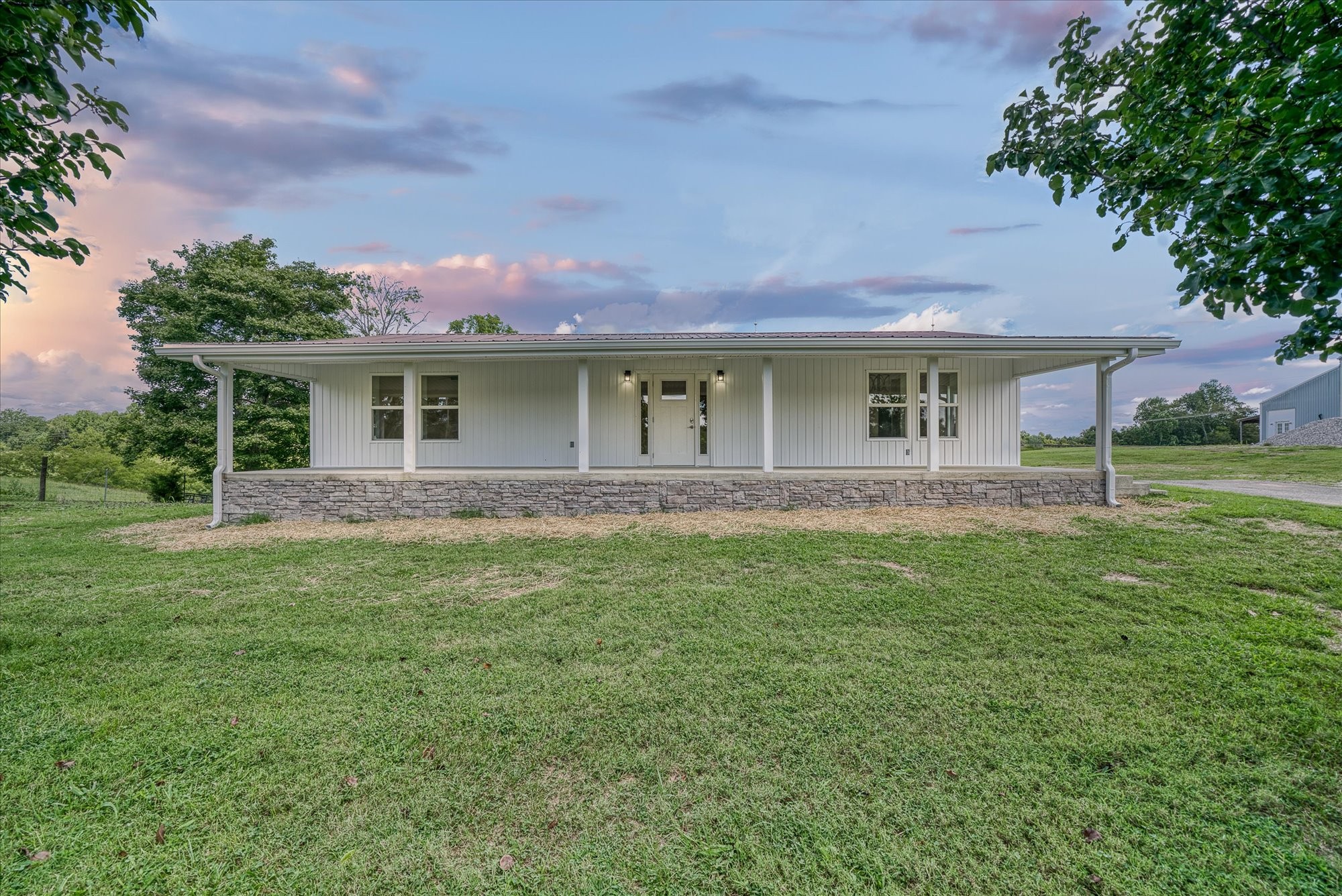 a front view of house with yard and green space