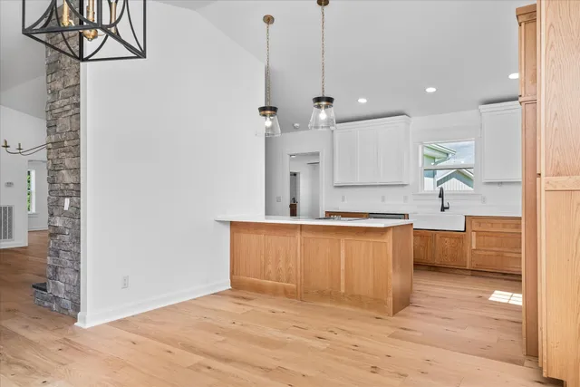 a large kitchen with kitchen island a sink stainless steel appliances and cabinets