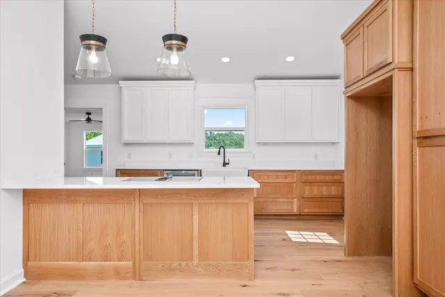a kitchen with stainless steel appliances a sink stove and cabinets