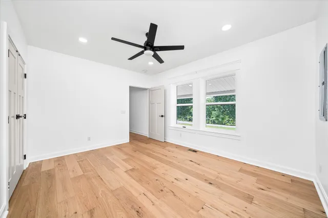 a view of a livingroom with a ceiling fan and window