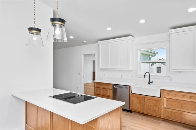 a kitchen that has a sink a stove and a refrigerator