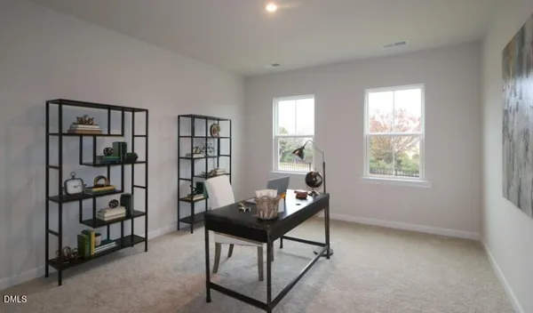 a living room with furniture a window and a book shelf