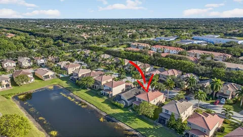 an aerial view of residential houses with outdoor space and trees
