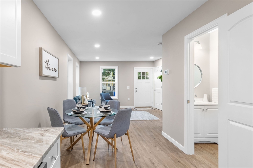 121-123 Putnam Circle Springfield, MA 01104 - Photo 4 of 18 a view of a dining room with furniture and wooden floor