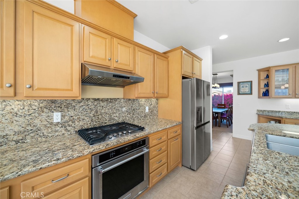 1147 Contessa Way Nipomo, CA 93444 - Photo 11 of 57 a kitchen with stainless steel appliances granite countertop a refrigerator stove and cabinets