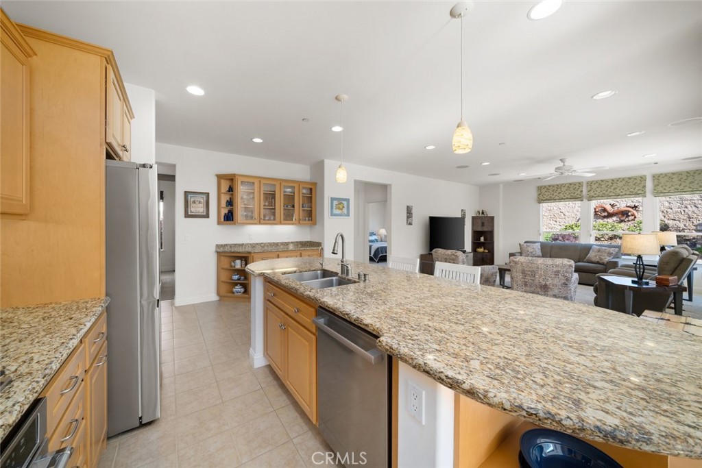 1147 Contessa Way Nipomo, CA 93444 - Photo 12 of 57 a kitchen with stainless steel appliances granite countertop a sink refrigerator and cabinets
