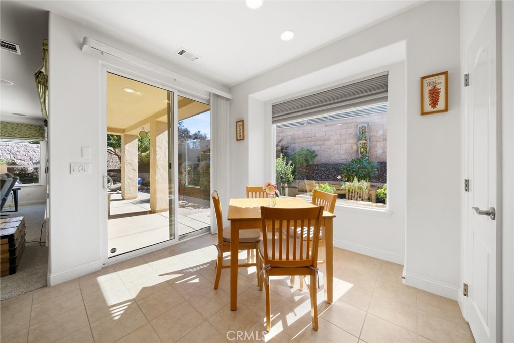 1147 Contessa Way Nipomo, CA 93444 - Photo 13 of 57 a dining room with furniture a chandelier and wooden floor