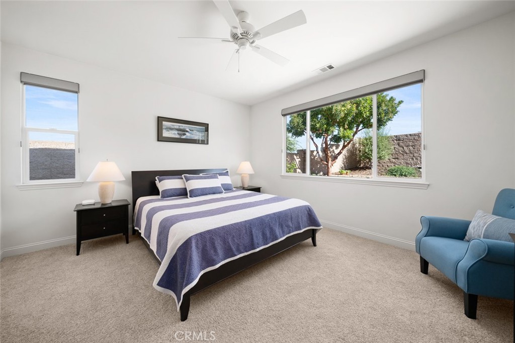 1147 Contessa Way Nipomo, CA 93444 - Photo 22 of 57 a bedroom with a large bed couch and a window
