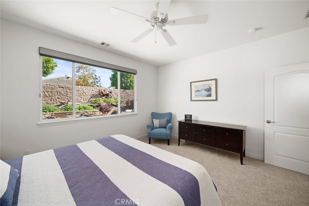 1147 Contessa Way Nipomo, CA 93444 - Photo 23 of 57 a bedroom with a bed painting on wall and a large window