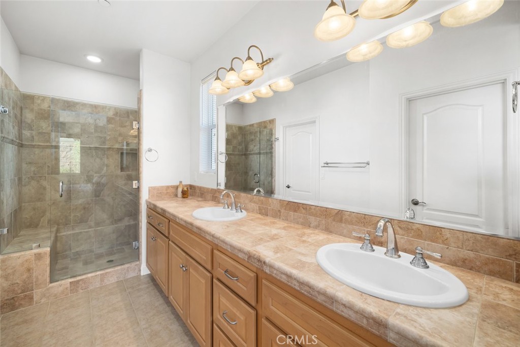 1147 Contessa Way Nipomo, CA 93444 - Photo 25 of 57 a bathroom with a sink a mirror and a shower
