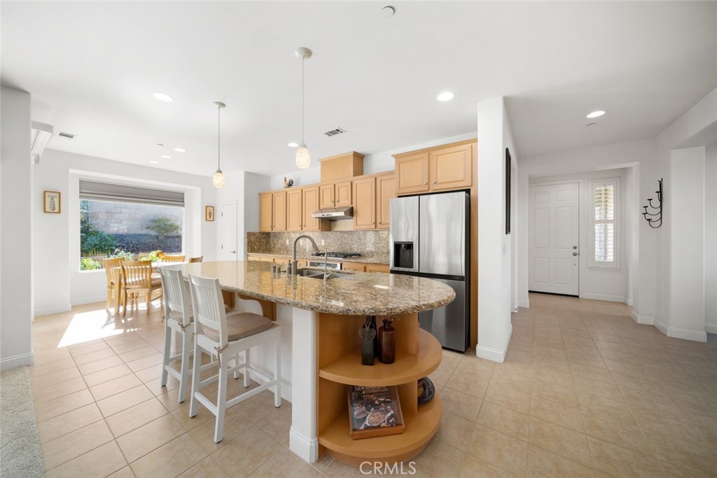 1147 Contessa Way Nipomo, CA 93444 - Photo 10 of 57 a room with stainless steel appliances kitchen island granite countertop furniture and a view of kitchen
