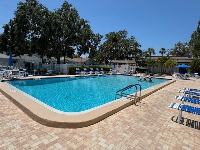 11485 Oakhurst Road, Unit 319 Largo, FL 33774 - Photo 59 of 63 a view of a swimming pool with outdoor seating