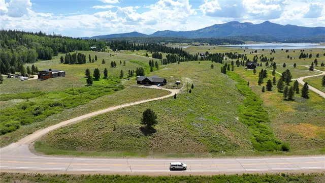 a view of a lush green hillside and houses