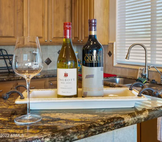 a kitchen with stainless steel appliances granite countertop a refrigerator a sink and a stove