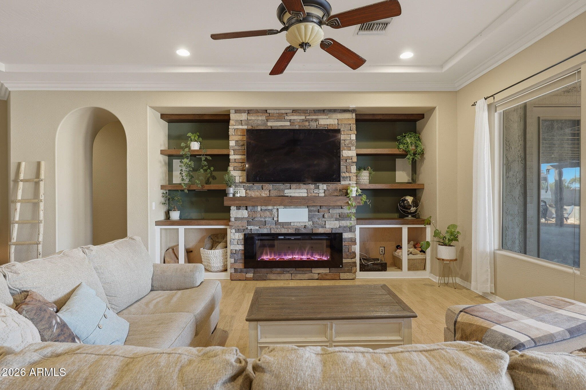 23024 West Sierra Ridge Way Wittmann, AZ 85361 - Photo 30 of 99 a living room with furniture and a fireplace