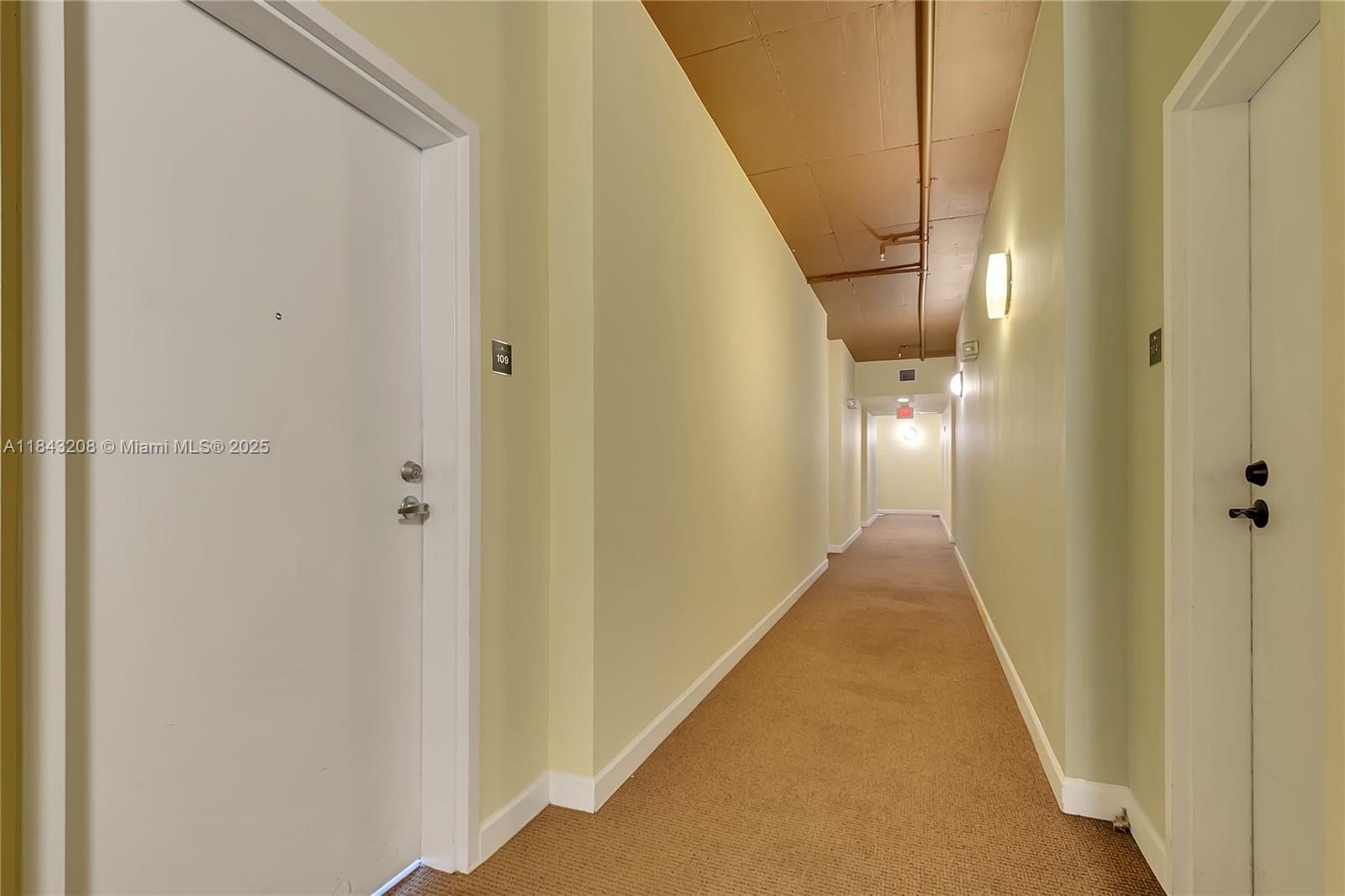 1350 Northwest 8th Court, Unit B5 Miami, FL 33136 - Photo 19 of 21 a view of a hallway with wooden floor and staircase