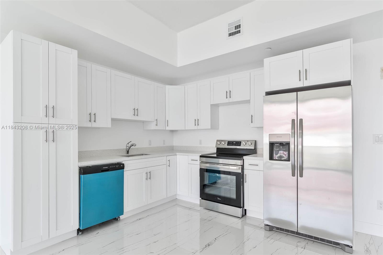 1350 Northwest 8th Court, Unit B5 Miami, FL 33136 - Photo 2 of 21 a kitchen with cabinets stainless steel appliances and a counter space