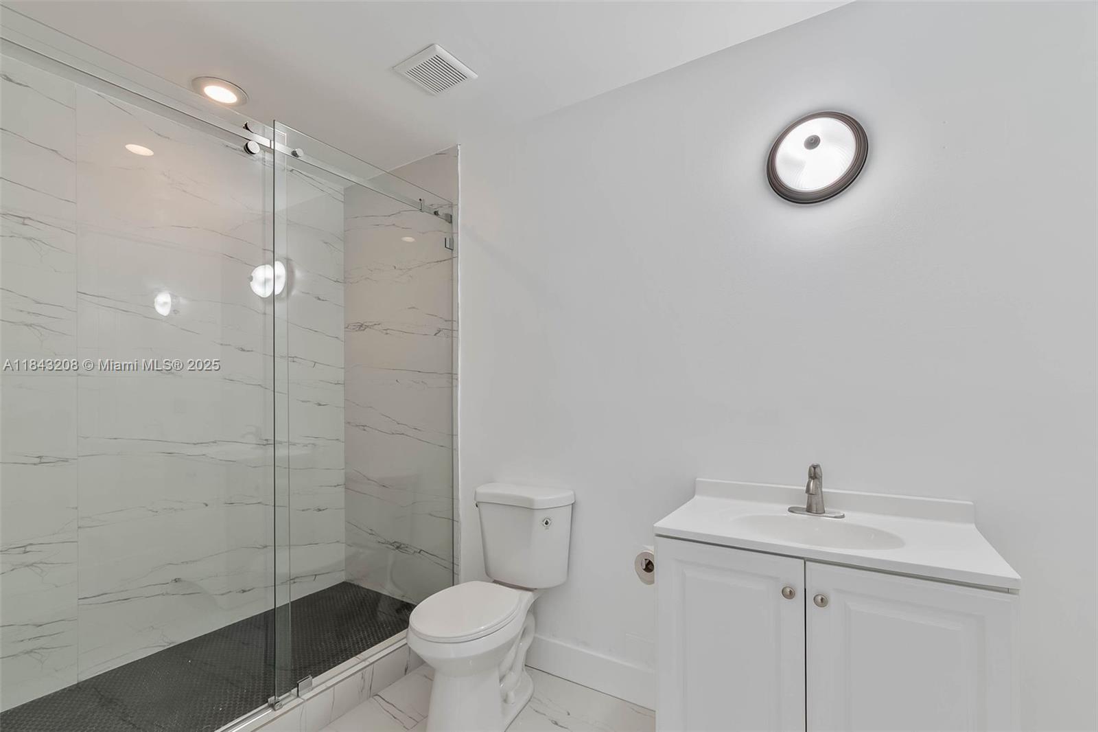 1350 Northwest 8th Court, Unit B5 Miami, FL 33136 - Photo 7 of 21 a bathroom with a sink a toilet and shower