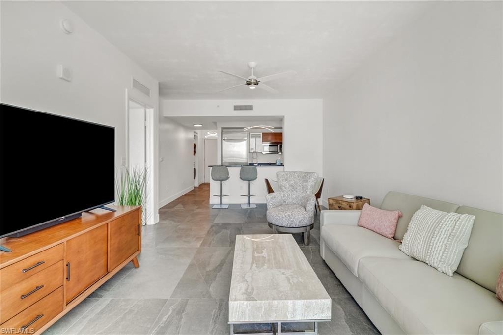 3000 Oasis Grand Boulevard, Unit 606 Fort Myers, FL 33916 - Photo 11 of 47 a living room with furniture and a flat screen tv