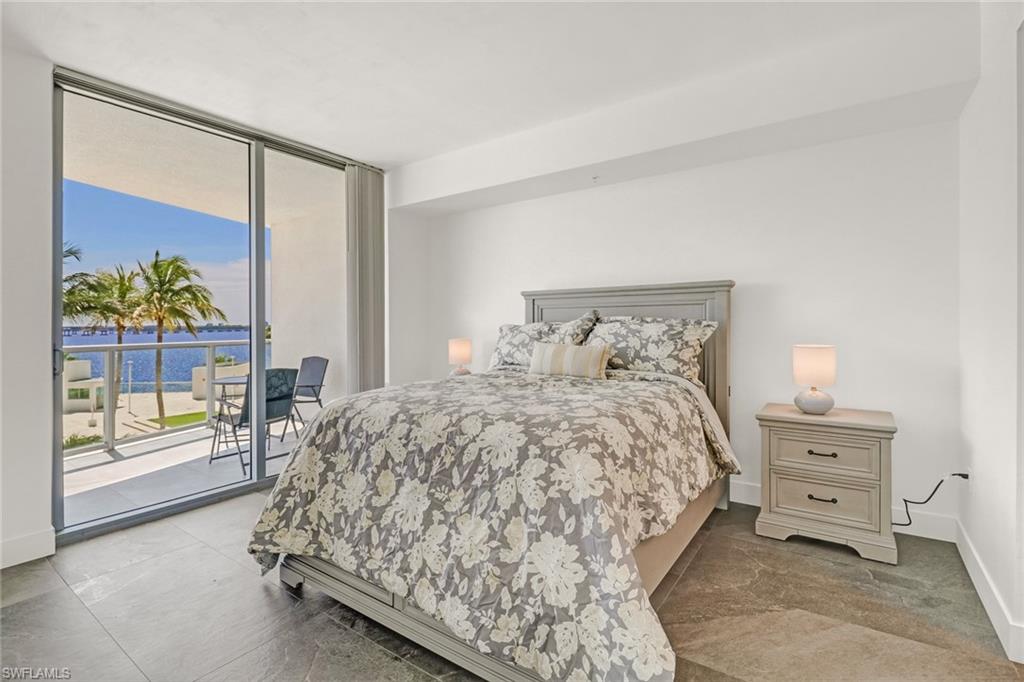 3000 Oasis Grand Boulevard, Unit 606 Fort Myers, FL 33916 - Photo 17 of 47 a bedroom with a bed and a painting on the wall