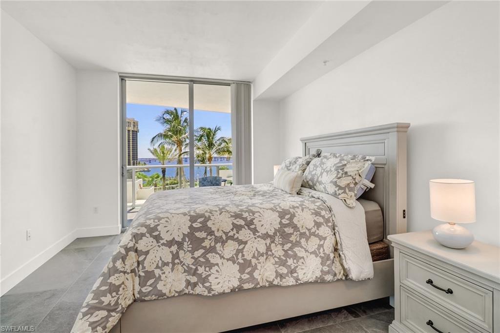 3000 Oasis Grand Boulevard, Unit 606 Fort Myers, FL 33916 - Photo 18 of 47 a bedroom with a bed and a window