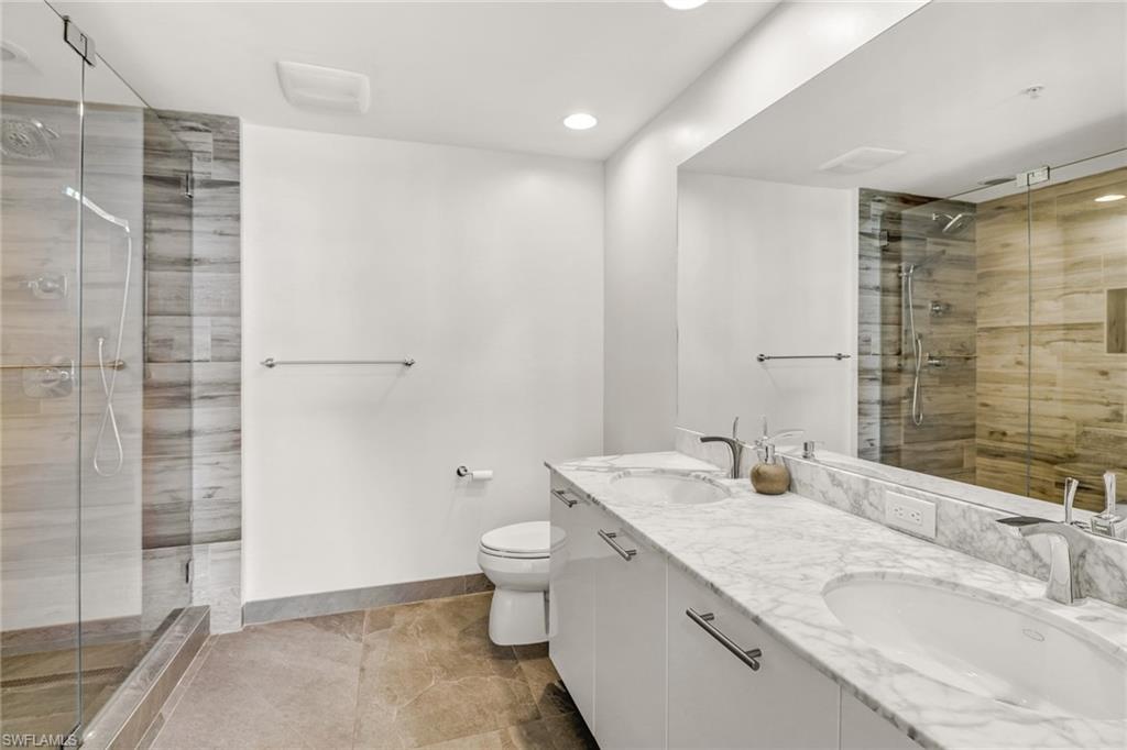 3000 Oasis Grand Boulevard, Unit 606 Fort Myers, FL 33916 - Photo 21 of 47 a bathroom with a granite countertop sink a toilet and shower