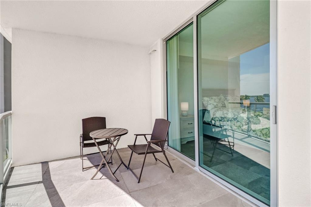 3000 Oasis Grand Boulevard, Unit 606 Fort Myers, FL 33916 - Photo 25 of 47 a balcony with chairs and a table