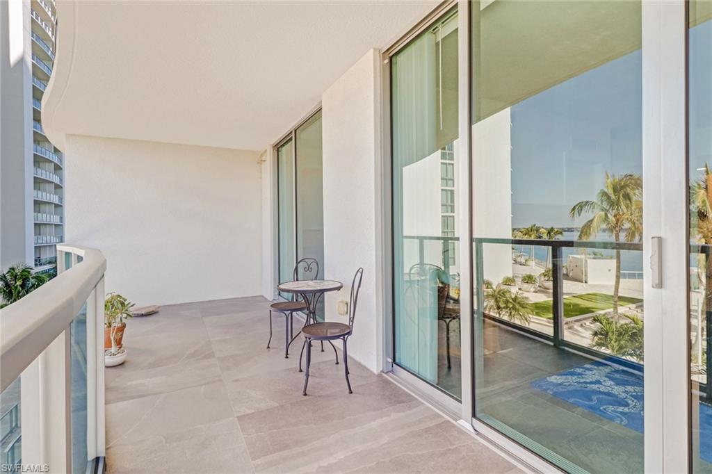 3000 Oasis Grand Boulevard, Unit 606 Fort Myers, FL 33916 - Photo 27 of 47 a view of an entryway with wooden floor and a bench