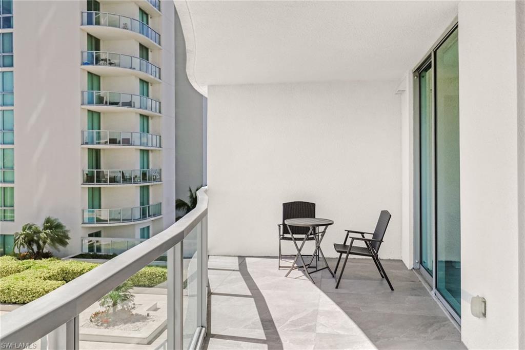 3000 Oasis Grand Boulevard, Unit 606 Fort Myers, FL 33916 - Photo 28 of 47 a city view from a balcony with furniture