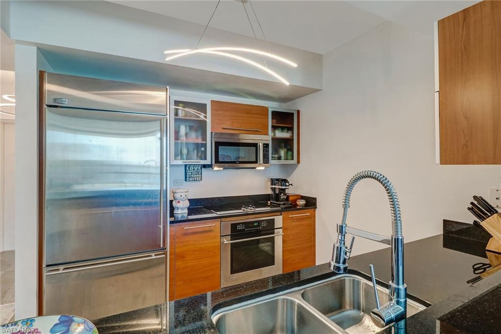 3000 Oasis Grand Boulevard, Unit 606 Fort Myers, FL 33916 - Photo 3 of 47 a kitchen with a refrigerator and a sink