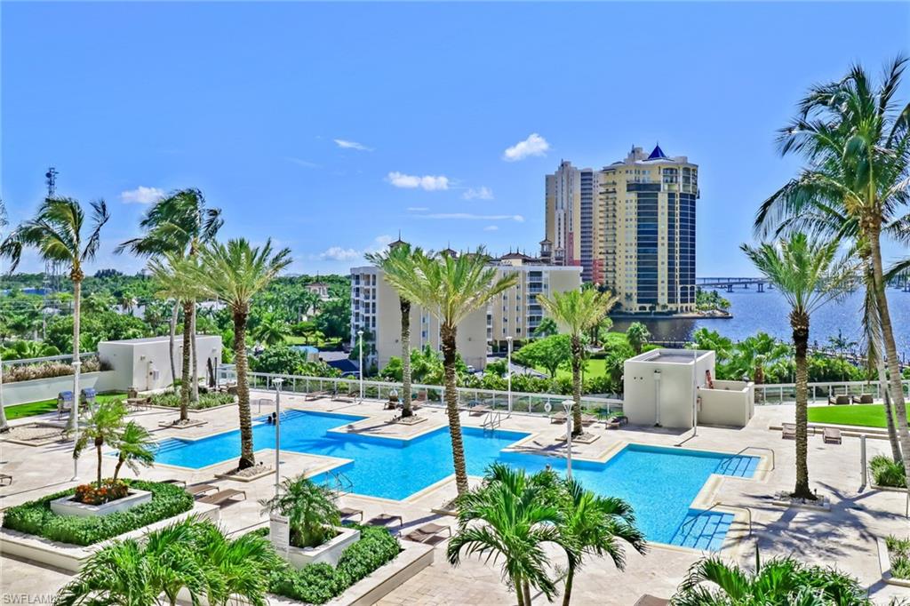 3000 Oasis Grand Boulevard, Unit 606 Fort Myers, FL 33916 - Photo 32 of 47 a view of a swimming pool with chairs