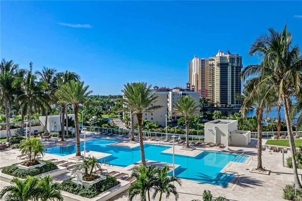 3000 Oasis Grand Boulevard, Unit 606 Fort Myers, FL 33916 - Photo 33 of 47 a view of a swimming pool with chairs