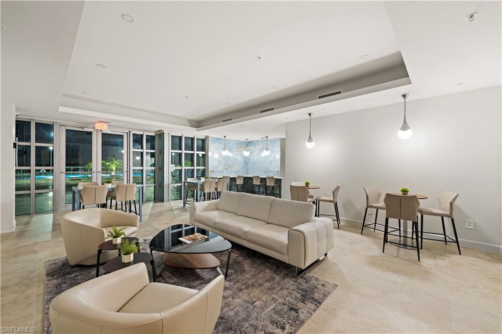 3000 Oasis Grand Boulevard, Unit 606 Fort Myers, FL 33916 - Photo 36 of 47 a living room with furniture and a large window