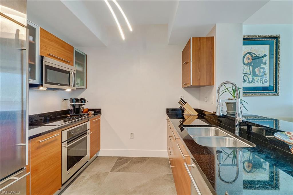 3000 Oasis Grand Boulevard, Unit 606 Fort Myers, FL 33916 - Photo 4 of 47 a kitchen with granite countertop a sink and a stove top oven