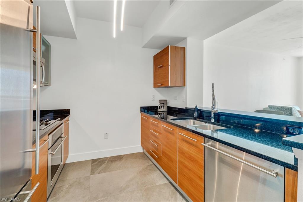 3000 Oasis Grand Boulevard, Unit 606 Fort Myers, FL 33916 - Photo 5 of 47 a room with stainless steel appliances granite countertop a sink and a granite counter tops