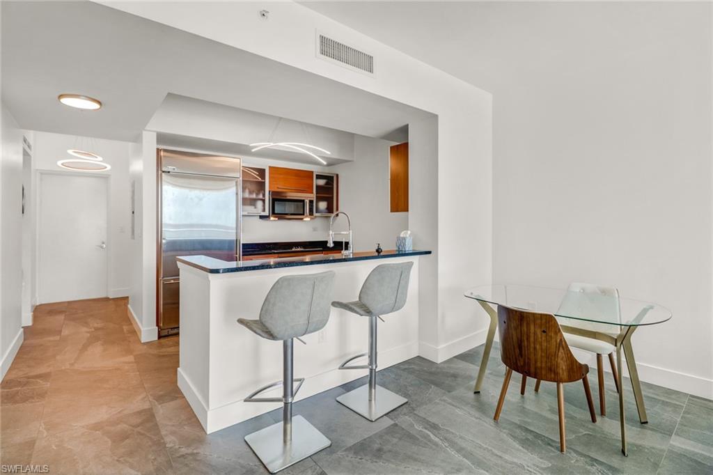 3000 Oasis Grand Boulevard, Unit 606 Fort Myers, FL 33916 - Photo 9 of 47 a living room with furniture and a flat screen tv