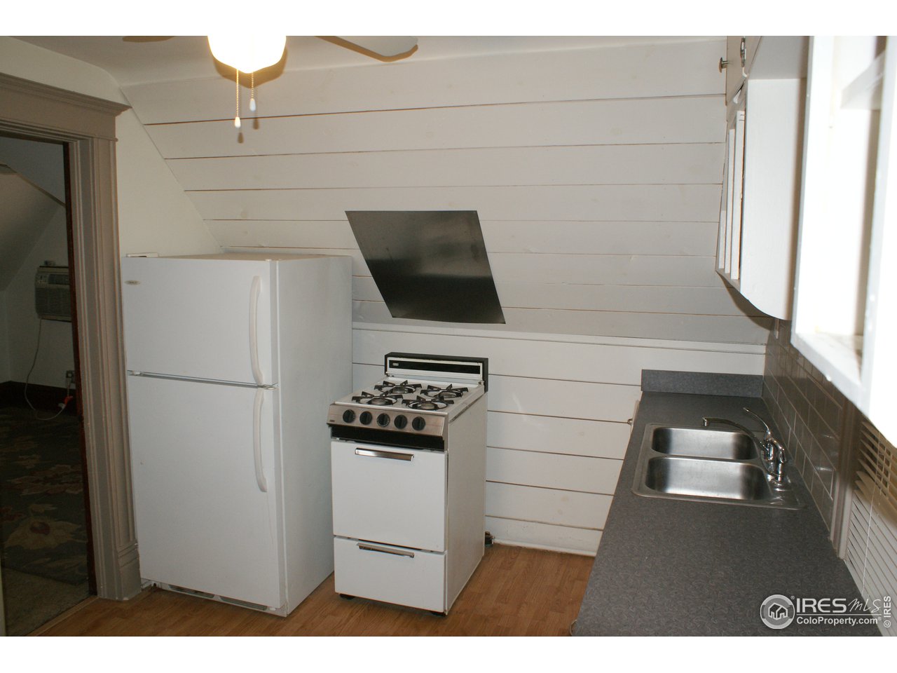 175 South Main Street Brighton, CO 80601 - Photo 11 of 13 a kitchen with a refrigerator and cabinets