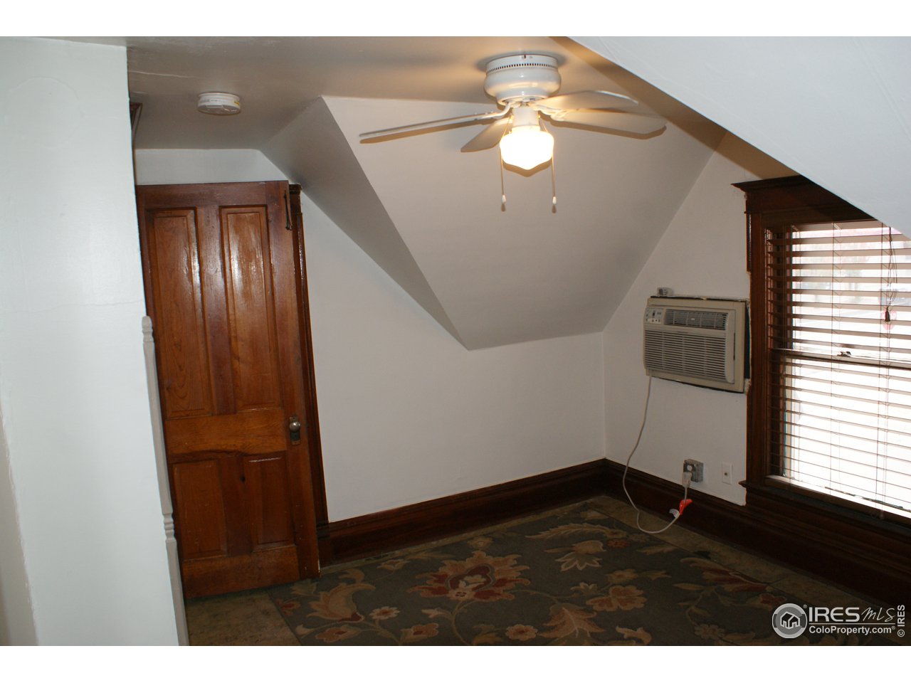 175 South Main Street Brighton, CO 80601 - Photo 10 of 13 a view of an empty room with wooden floor