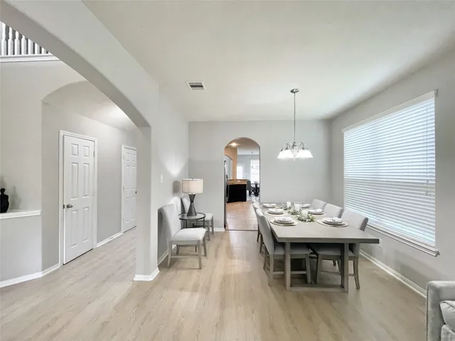 a living room with furniture a table and chairs