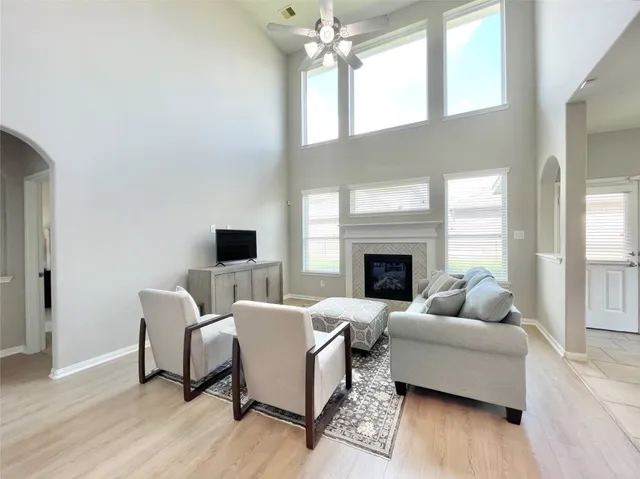 a living room with furniture fireplace and window