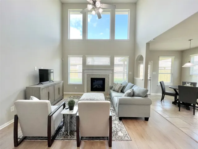 a living room with furniture a fireplace and a flat screen tv
