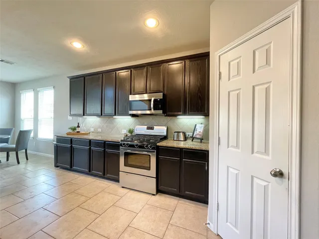 a large kitchen with cabinets
