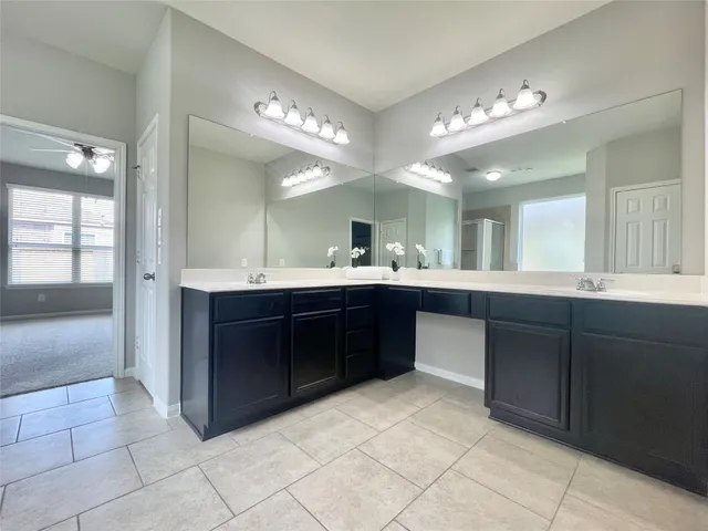 a spacious bathroom with a sink vanity and a mirror