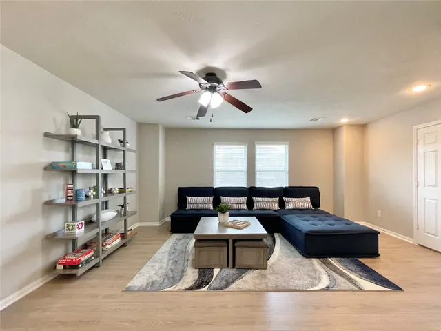 a living room with furniture a air conditioner and a table