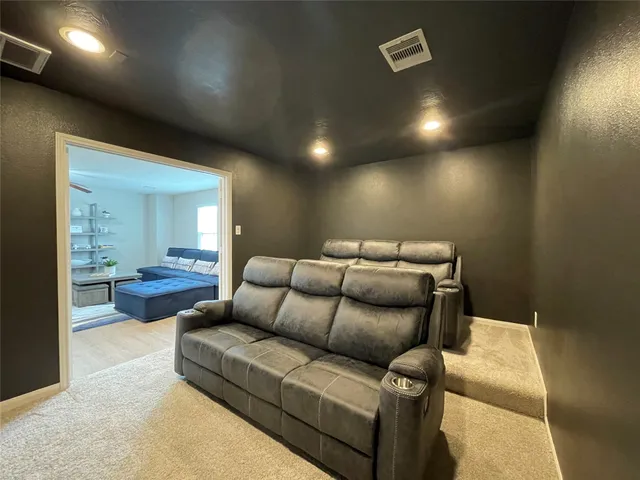 a living room with furniture and a glass door