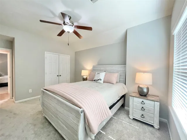 a bedroom with a bed and window