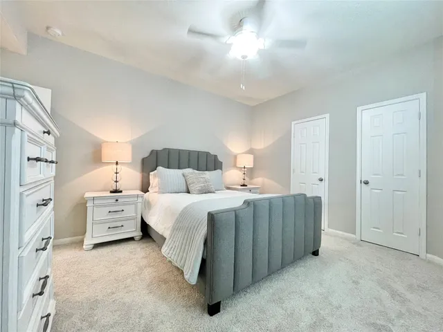 a large bedroom with a bed and a chandelier