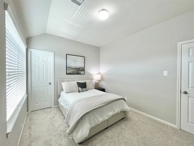 a bedroom with a bed and a window